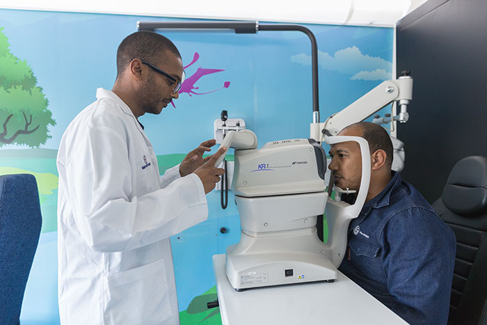 Man receiving an optometry test in mobile clinic