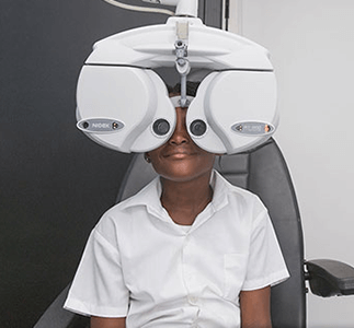 Kid receiving an optometry test in mobile clinic